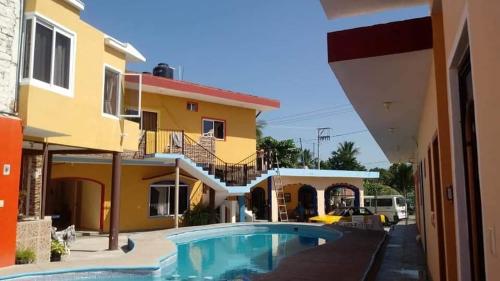 a house with a swimming pool in front of it at Bungalows Lulu in Bucerías