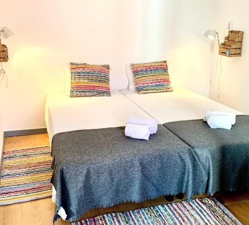 two beds sitting next to each other in a room at Peneco Albufeira GuestHouse in Albufeira