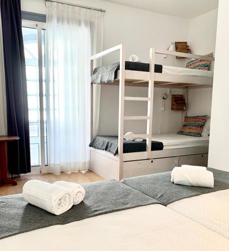 a bedroom with bunk beds with towels on the floor at Peneco Albufeira GuestHouse in Albufeira