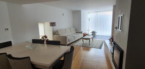 a living room with a table and a couch at Casas de Campo da Barroca in Tabosa