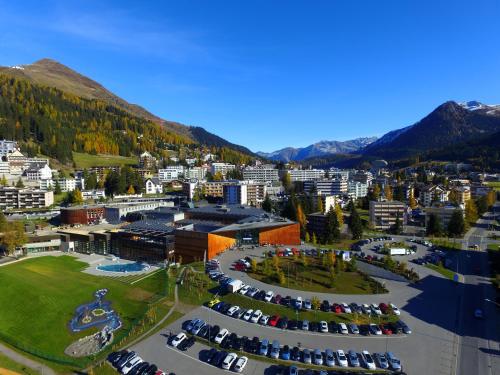 an aerial view of a city with cars parked in a parking lot at Davos Holiday Apartment in Davos