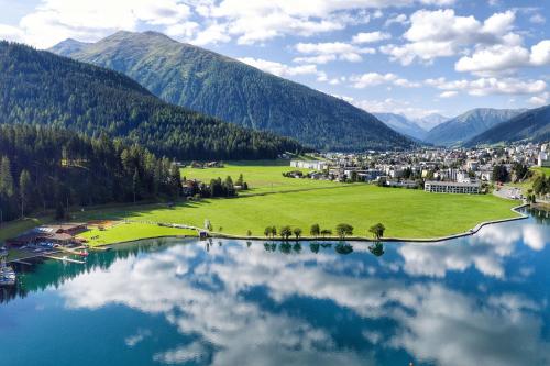 a view of a town with a lake and mountains at Davos Holiday Apartment in Davos