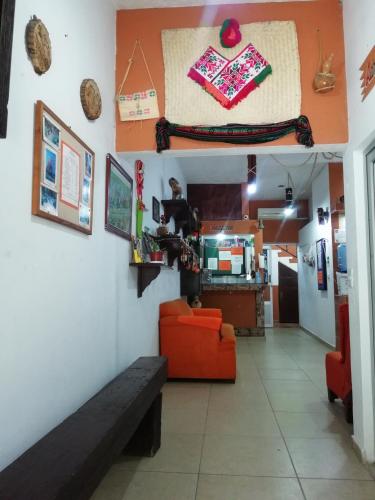 a living room with a red couch and a table at Kali Huasteca Posada in Ciudad Valles