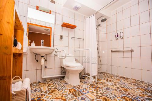 a bathroom with a toilet and a sink at Hotel Casa Algarrobo in San Pedro de Atacama