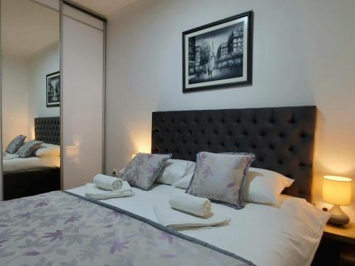 a bedroom with a bed with two towels on it at Zlatibor Hills Royal in Zlatibor
