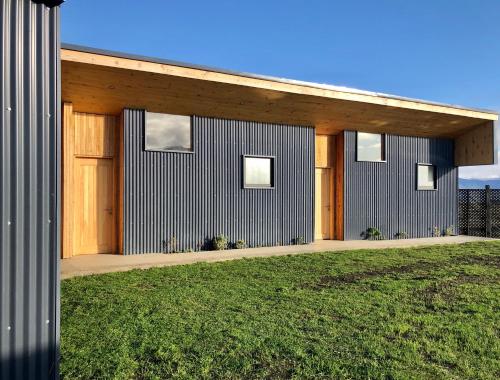 a modern house with a wooden facade at Line Hotel Patagonia in Puerto Natales