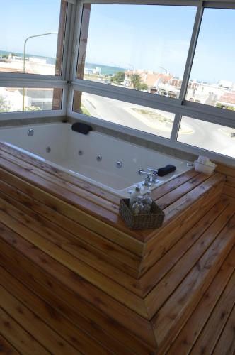 a bath tub in a room with a window at Complejo Bahia Ballenas in Rawson