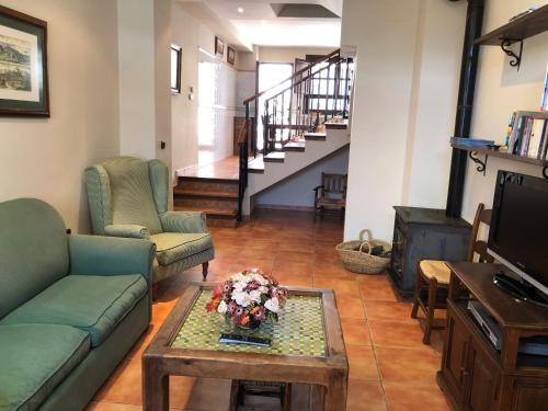 a living room with two couches and a coffee table at La casa de Tita Elvira 2 in Zafarraya