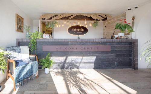 a store front with a welcome center sign and plants at Chuidasun Resort Tea & Meditation in Seogwipo