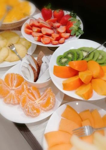 a table topped with plates of fruits and vegetables at BARI 102 in Bari