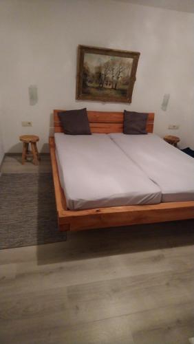 a large wooden bed in a room with at Ferienwohnung Alpina Inzell in Inzell
