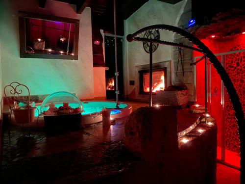 a room with a tub in a room with a fireplace at Il Giardino dei Flintstones B&B in Cerveteri