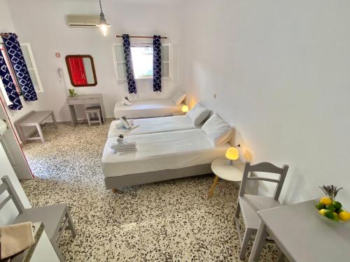 a small living room with a bed and a table at Anna Studios in Katapola