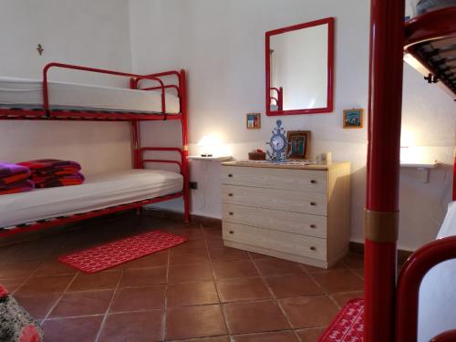 a bedroom with two bunk beds and a dresser at Great Apartment Stintino in Stintino