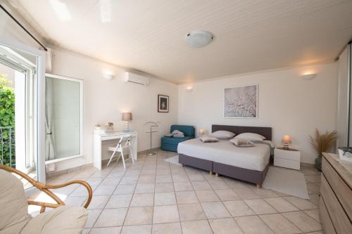a bedroom with a bed and a desk in it at Villa Tomić Apartment Mia near the sea in Opatija