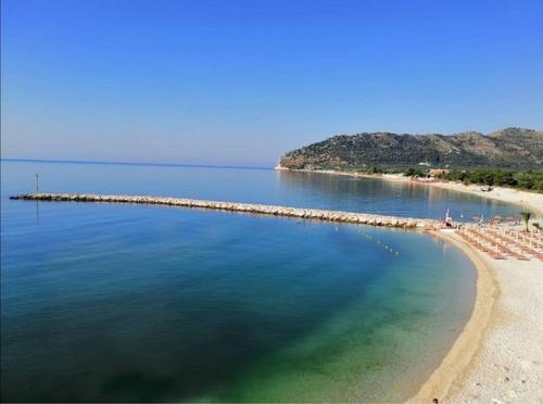 a view of a beach with umbrellas and the ocean at Hotel Il Melograno in Mattinata