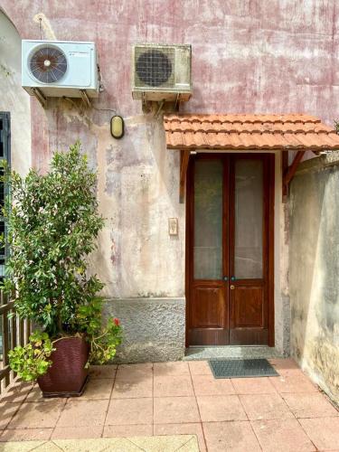 a building with a wooden door and a window at Casa di Marco in Galatina