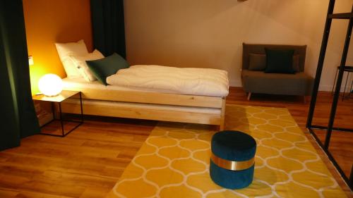 a bedroom with a bed and a chair in it at La Rochelle et l'Aunis in Saint-Sauveur-dʼAunis