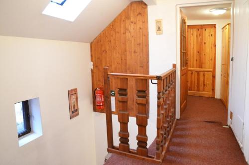 a staircase in a home with wood paneling and a hallway at Maxova Bouda in Josefuv dul