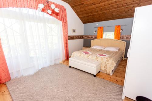 a bedroom with a bed and a large window at Guest House Rannaliiv in Võsu