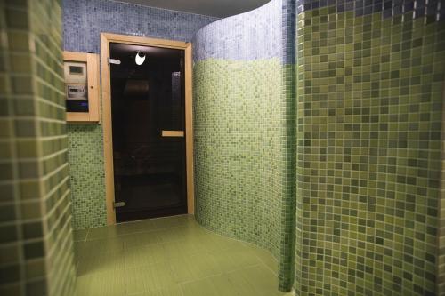 a bathroom with a door open and a shower curtain at Hotel Portofino in Włocławek
