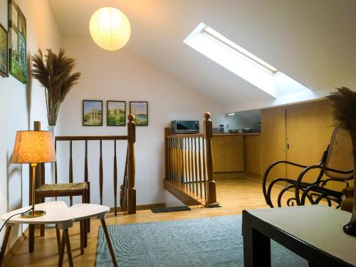 a living room with a skylight and a table and chairs at Willa Zdrój in Ciechocinek