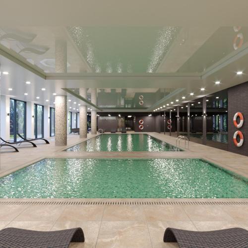a large swimming pool in a building at NovumApartamenty in Kołobrzeg