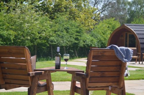 a table with a bottle of wine and a glass at Ribblesdale Pods in Horton in Ribblesdale