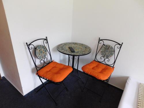 a table and two chairs with a table and a table at Pension U Mojmíra in Rokytnice nad Jizerou
