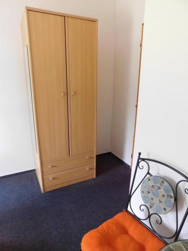 a bedroom with a bed and a cabinet at Pension U Mojmíra in Rokytnice nad Jizerou