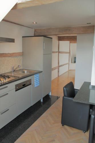 a kitchen with a sink and a counter top at Apartment De Maasnacht in Maaseik