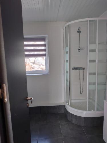 a bathroom with a shower with a glass door at Ferienwohnung Marlene in San Bartolomé