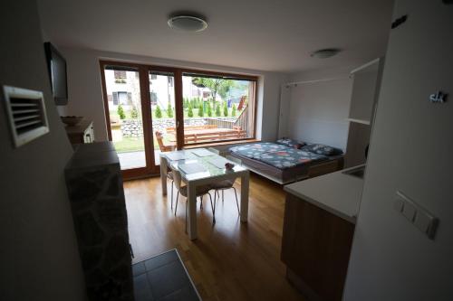 a living room with a bed and a table at APARTMENT ALPIN BOVEC in Bovec