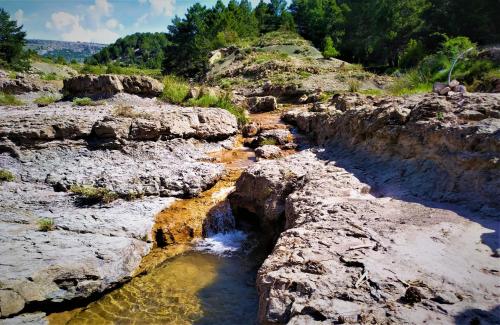 a stream of water in a rocky canyon at Hotel Rural Curia in El Castellar
