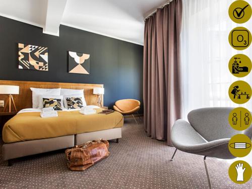 a room with a bed, chair, lamp and a painting on the wall at Zulian Aparthotel by Artery Hotels in Krakow