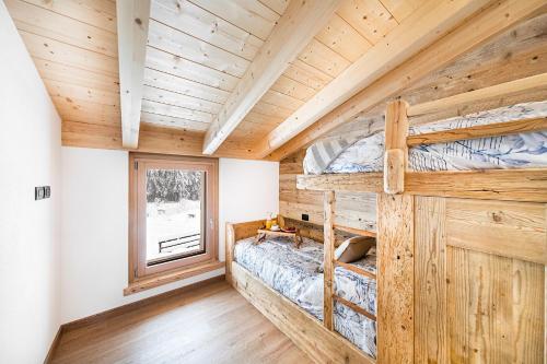 Krevet ili kreveti na kat u jedinici u objektu Chalet Resort Sozzine