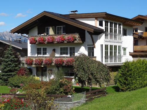 a house with flower boxes on the side of it at Appartements Loisachpromenade in Ehrwald