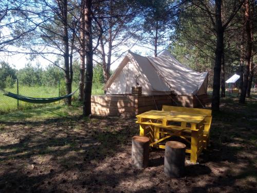 a yurt with a picnic table and a hammock at Kompleks Małe Dolomity in Hucisko