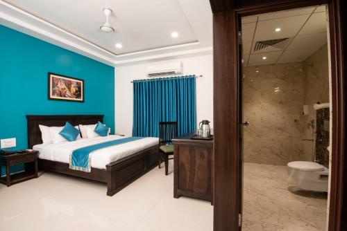 a bedroom with a bed and a bathroom with a shower at Hotel The Balam in Jodhpur