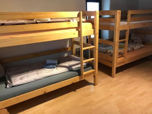 two sets of bunk beds in a room at Ostello Orgnana in Magadino