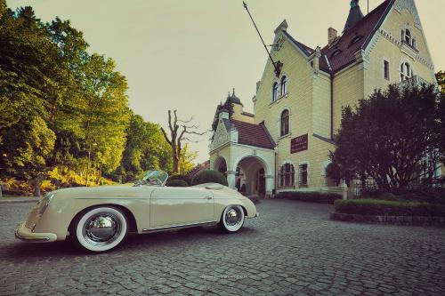 a white car parked in front of a building at Hotel Bursztynowy Pałac in Koszalin