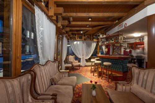 a living room filled with furniture and a couch at Hotel Chalet Swiss in Interlaken