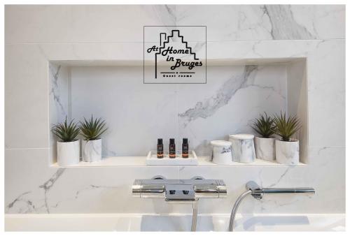 a bathroom with a sink and a white wall at at Home in Bruges in Bruges