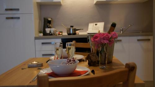 a kitchen table with a bowl and flowers on it at Les petits nids de Nina 1 in Fosses-La-Ville