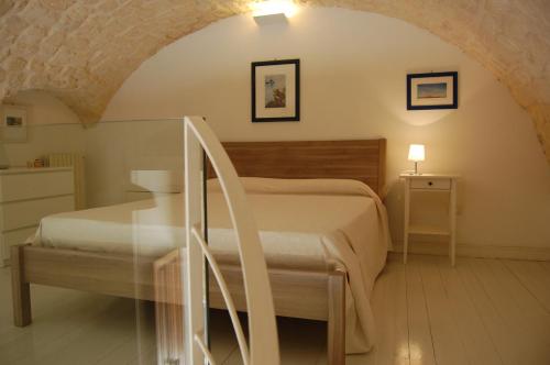 a bedroom with a bed and a glass staircase at Profumo Di Gelsomino in Scicli