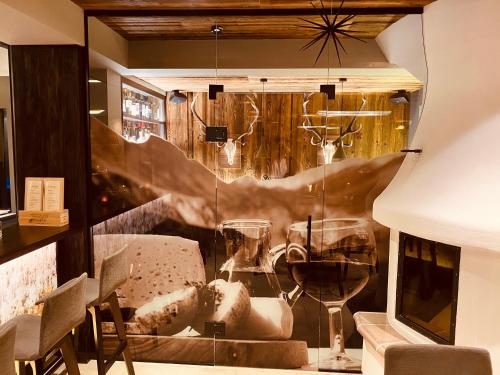 a window of a restaurant with a glass of wine at Hotel CENTRAL Bar & Restaurant in Gerlos