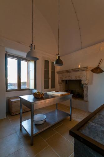 a living room with a table and a fireplace at Galeta Masseria in Nardò