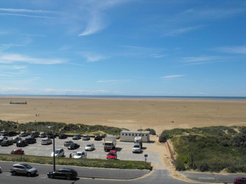 a parking lot with a beach in the background at Monterey Beach Hotel in Lytham St Annes