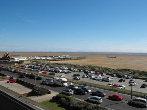 a parking lot at the beach with cars parked at Monterey Beach Hotel in Lytham St Annes