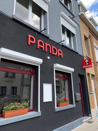 
a red brick building with a sign on the side of it at Panda Bella in Zaventem
